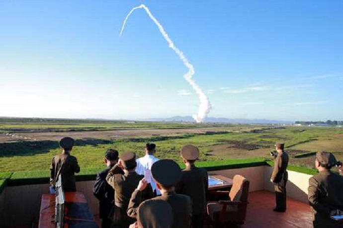 North Korean leader Kim Jong Un watches the test of a new-type anti-aircraft guided weapon system organised by the Academy of National Defence Science