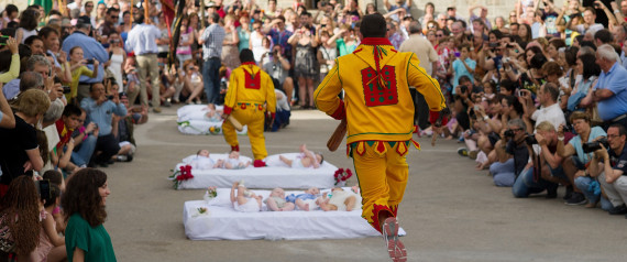 CASTRILLO DE MURCIA, SPAIN - JUNE 22:  A man representing the devil leaps over babies during the festival of El Salto del Colacho (the devil's jump) on June 22, 2014 in Castrillo de Murcia, Spain. The festival, held on the first Sunday after Corpus Cristi, is a catholic rite of the devil cleansing babies of original sin. (Photo by Denis Doyle/Getty Images)