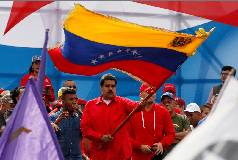 Venezuela's President Nicolas Maduro waves a national flag during a rally in Caracas, Venezuela, Thursday, July 27, 2017.Venezuelan President Nicolas Maduro has provoked international outcry and enraged an opposition demanding his resignation with his push to elect an assembly that will rewrite the troubled South American nation’s constitution. Sunday’s election will cap nearly four months of political upheaval that has left thousands detained and injured and at least 100 dead. (AP Photo/Ariana Cubillos)