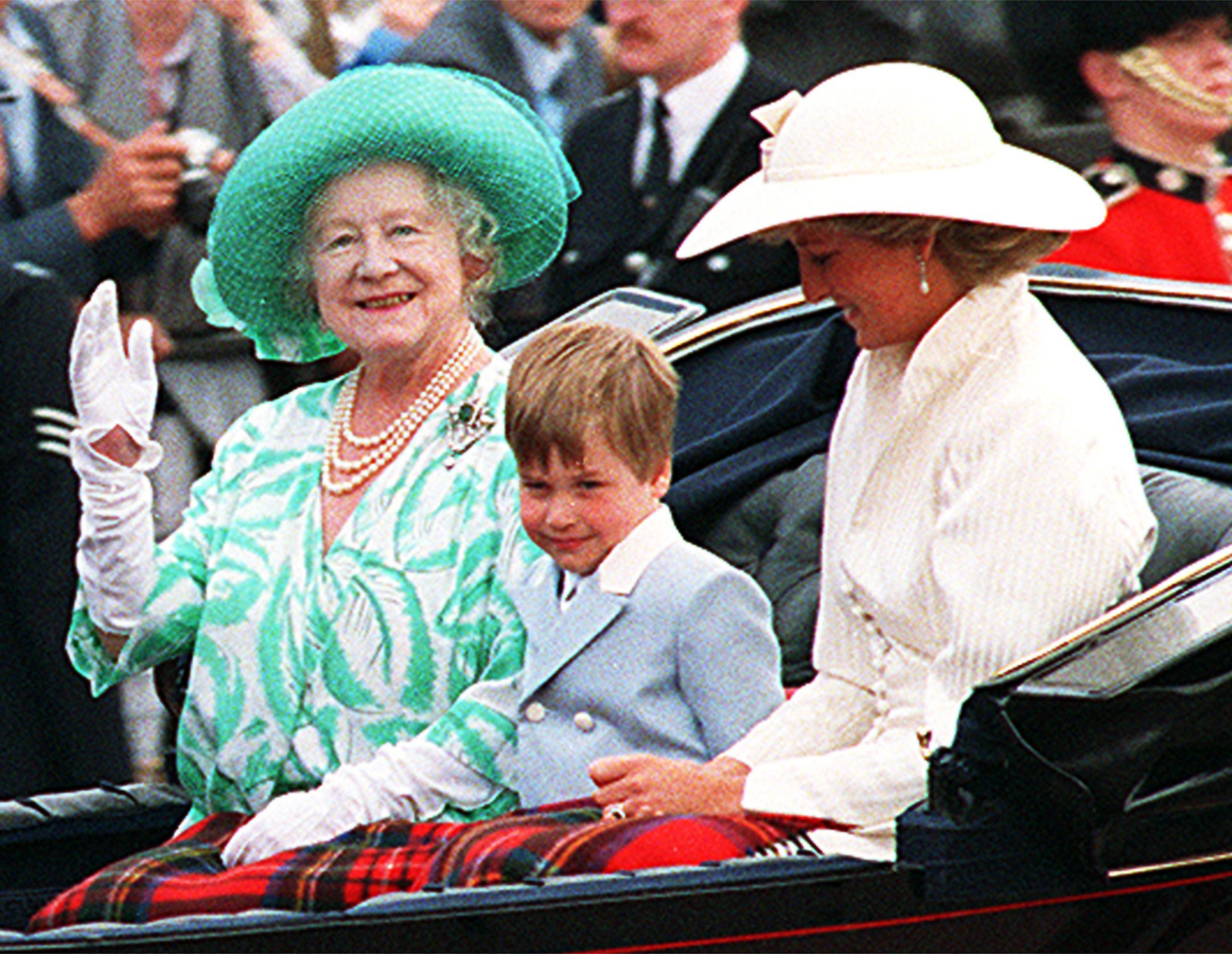 FILE - In this June 13, 1987 file photo, Britain's Queen Elizabeth rides in an open coach with her great-grandson, Prince William, and his mother Diana, Princess of Wales, during the Queen Mother's 87th birthday anniversary parade in London. Prince William is spending the latter half of his four-day stay in Japan, starting Saturday, Feb. 28, 2015 in the country's tsunami-ravaged northeast, a visit certain to draw global attention to the stories of survival and continuing suffering in the region. Memories of William's mother, who died in 1997, are everywhere. The media in Japan, a culture that traditionally values male heirs, have been referring to him as "Diana's first-born son," as though that was more important than his being second in line to the throne. (AP Photo/Gill Allen, File)