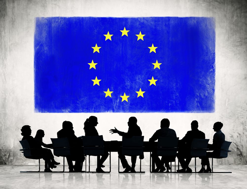 Business People Discussing with Flag of European Union Behind