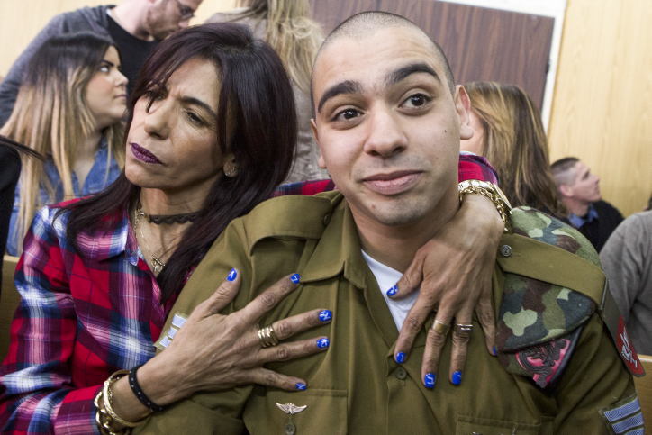 IDF Sgt. Elor Azaria, the Israeli soldier, who shot dead a disarmed and injured Palestinian attacker in the West Bank city of Hebron on March 24, 2016, is surrounded by family and friends as he awaits to hear his sentence in a courtroom at the Kirya military base in Tel Aviv, on February 21, 2017. Azaria was convicted for manslaughter, he was sentenced to 18 months in military prison. Photo by Jim Hollander/POOL **CREDIT MUST BE GIVEN, FOR USE ONLY IN ISRAEL, AGENCIES OUT**