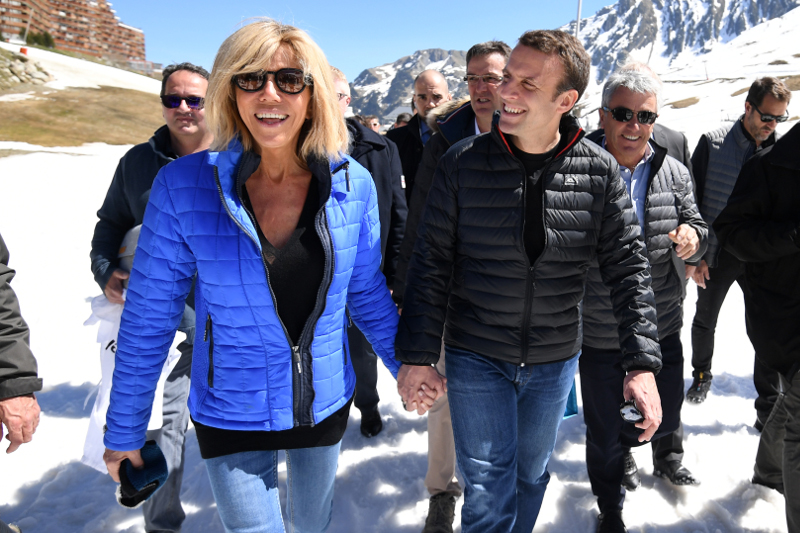 French centrist presidential election candidate Emmanuel Macron, right, and his wife Brigitte Trogneux arrive for a lunch break at the mountain top during a campaign visit in Bagneres-de-Bigorre, Pyrenees mountains, France, Wednesday, April 12, 2017. (Eric Feferberg/Pool Photo via AP)