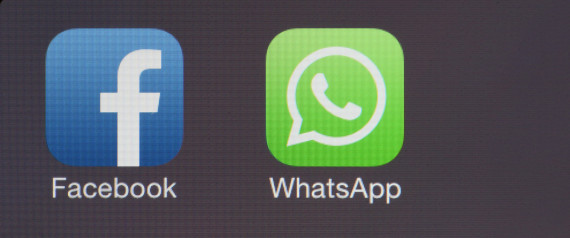 Icons for the WhatsApp Inc. mobile-messaging application WhatsApp and the Facebook Inc. application are displayed in a social media folder on the screen of an Apple Inc. iPhone in this arranged photograph taken in London, U.K., on Thursday, Feb. 20, 2014. Facebook, the worlds largest social network, agreed to acquire mobile-messaging startup WhatsApp Inc. for as much as $19 billion in cash and stock, seeking to expand its reach among users on mobile devices. Photographer: Chris Ratcliffe/Bloomberg via Getty Images