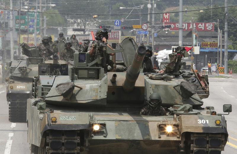 South Korean army soldiers ride K-1 tanks
during the annual exercise in Paju, near the border with North Korea, South Korea, Wednesday, July 5, 2017. North Korean leader Kim Jong Un vows his nation would "demonstrate its mettle to the U.S." and never negotiate its weapons programs after watching the test-launch of its first intercontinental ballistic missile. (AP Photo/Ahn Young-joon)