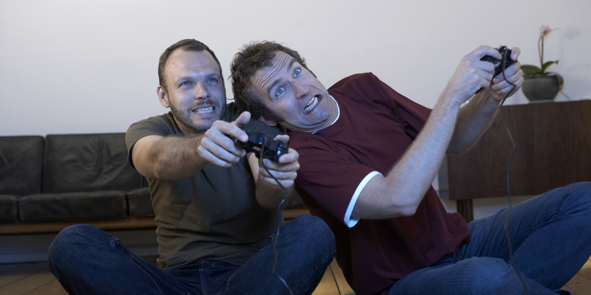 Two mid adult men playing video games