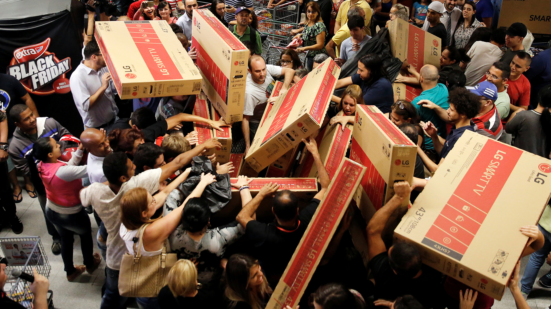 Shoppers reach for television sets as they compete to purchase retail items on Black Friday at a store in Sao Paulo, Brazil, November 24, 2016. REUTERS/Nacho Doce