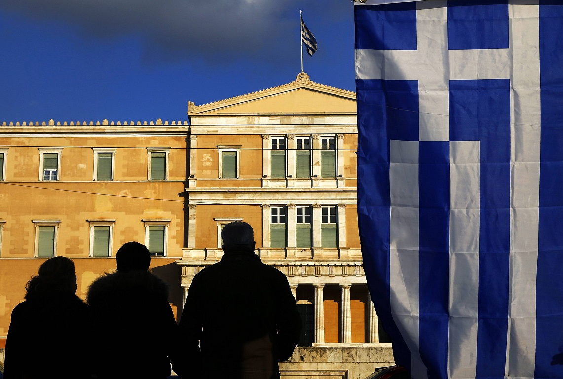 Protesters are silhouetted in front of the parliament during an anti-austerity and pro-government demonstration in Athens February 15, 2015. Greece has agreed with its European partners that there needs to be a "national reform plan" to deal with decades-long issues of the economy, its government spokesman said on Sunday. Greece and its euro zone partners are in difficult negotiations over demands by the new government of leftist Prime Minister Alexis Tsipras for an end to austerity and a renegotiation of Greece's debt. REUTERS/Yannis Behrakis (GREECE - Tags: POLITICS BUSINESS CIVIL UNREST TPX IMAGES OF THE DAY)