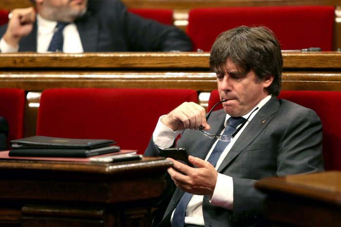 epa06187640 Catalonian regional President Carles Puigdemont checks his mobile device during recess in the plenary session at Catalonia's regional Parliament to vote on the referendum law, in Barcelona, Spain, 06 September 2017. The Catalan Government expects to hold a referendum on independece from the central Government next 01 October 2017, under the question 'Do you want Catalonia to be an independent state in the form of a republic?'. The planned vote will be held with the total opposition from the central government of the conservative Popular Party (PP), which has consistently appealed to the Constitutional Court to block the referendum.  EPA/TONI ALBIR