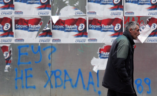 A man passes pre-election posters of Serbian President Boris Tadic, who leads the pro-Western Democratic Party, and a graffiti reading "EU? No thanks!" 17 January 2008 in Belgrade. Serbia's presidential vote on Sunday is seen as a chance for this Balkans country to choose its future path favoring either further integration into the European Union or strengthening ties with its traditional ally Russia. AFP PHOTO / ANDREJ ISAKOVIC (Photo credit should read ANDREJ ISAKOVIC/AFP/Getty Images)