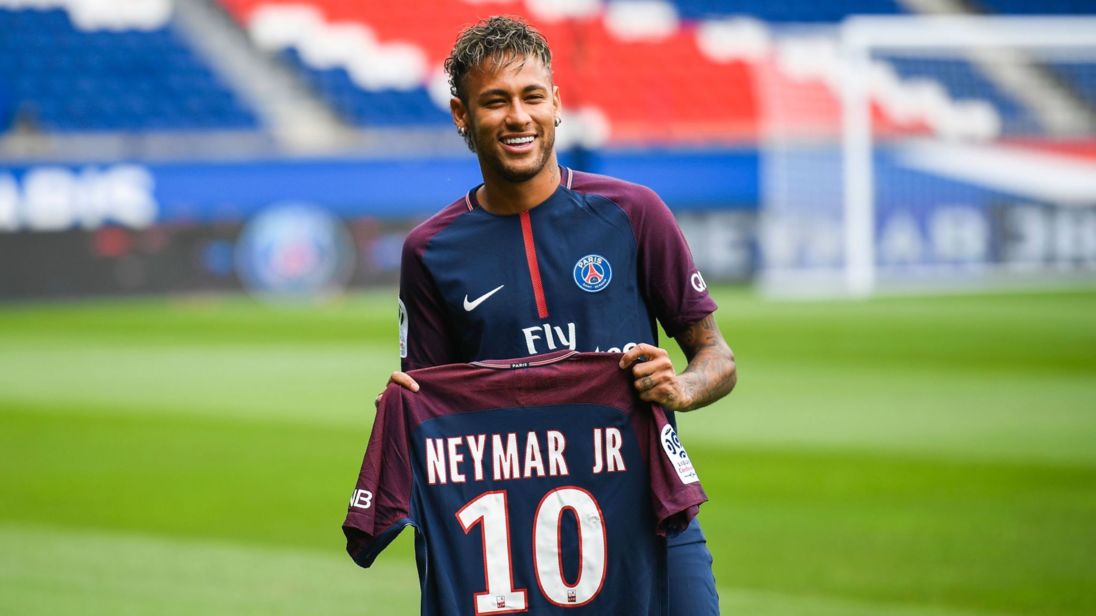 Brazilian superstar Neymar poses with his new jersey during his official presentation at the Parc des Princes stadium on August 4, 2017 in Paris after agreeing a five-year contract following his world record 222 million euro ($260 million) transfer from Barcelona to Paris Saint Germain's (PSG).
Paris Saint-Germain have signed Brazilian forward Neymar from Barcelona for a world-record transfer fee of 222 million euros (around $264 million), more than doubling the previous record. Neymar said he came to Paris Saint-Germain for a "bigger challenge" in his first public comments since arriving in the French capital. / AFP PHOTO / Lionel BONAVENTURE        (Photo credit should read LIONEL BONAVENTURE/AFP/Getty Images)