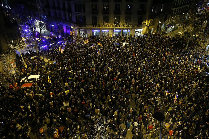 Large crowds gather in Barcelona, Spain, Friday, March 23, 2018 to protest the jailing of Catalan polititians. A Spanish Supreme Court judge has charged 13 leading Catalan separatist politicians with rebellion for their recent attempts to bring about the region's independence from Spain. The indictment deals a heavy blow to the secessionist movement as it could put its political elite behind bars for decades. (AP Photo/Manu Fernandez)