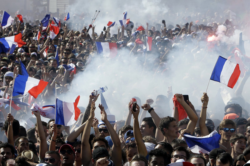 French soccer fans react as they watch a live broadcast on a big screen of the final match between France and Croatia at the 2018 soccer World Cup, in Marseille, southern France, Sunday, July 15, 2018. (AP Photo/Claude Paris)