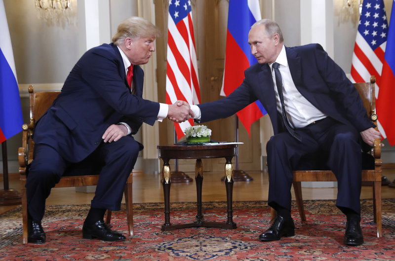 U.S. President Donald Trump, left, and Russian President Vladimir Putin shake hand at the beginning of a meeting at the Presidential Palace in Helsinki, Finland, Monday, July 16, 2018. (AP Photo/Pablo Martinez Monsivais)