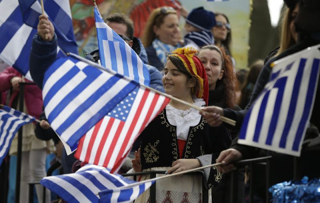 Youngsters and adults wave Greek and American flags from a float during the annual Greek parade in New York, Sunday, April 7, 2013.  (AP Photo/Kathy Willens)