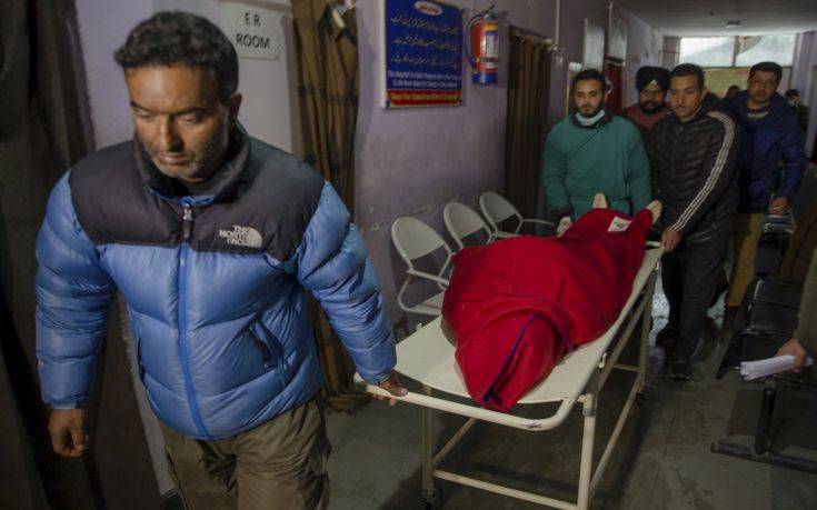Kashmiri paramedics shift the body of Russian skier who has been identified as 30-year-old Stanislav, at hospital in Tangmarg, near the tourist town of Gulmarg, Indian controlled Kashmir, Friday, Feb. 16, 2018. The Russian skier was killed by an avalanche that hit the Gulmarg tourist resort. Four other Russian skiers from the group were rescued. (AP Photo/Dar Yasin)