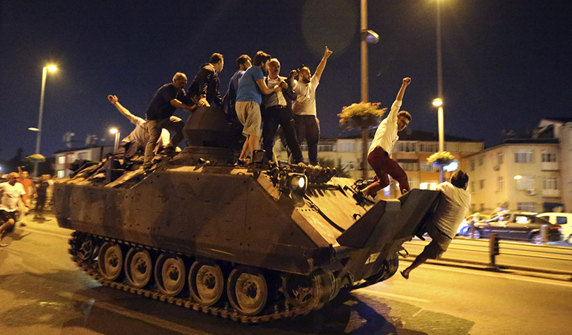 epa05427127 People occupy a tank in Istanbul, Turkey, 16 July 2016. Turkish Prime Minister Yildirim reportedly said that the Turkish military was involved in an attempted coup d'etat. The Turkish military meanwhile stated it had taken over control.  EPA/TOLGA BOZOGLU