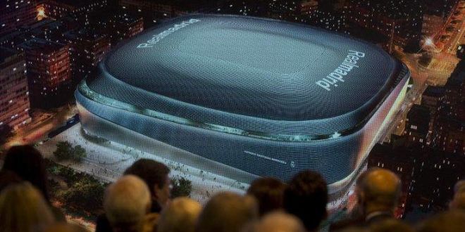 Real Madrid board of directors and guests watch a projection of a artist's image of the proposed new Santiago Bernabeu stadium during a presentation to remodel the stadium in Madrid, Spain, Tuesday, April 2, 2019. (AP Photo/Paul White)