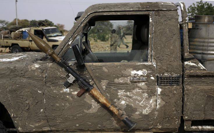 A rocket propelled launcher hangs on the mirror of a camouflaged Chadian pickup truck in the Nigerian city of Damasak, Nigeria, Wednesday, March 18, 2015. Damasak was flushed of Boko Haram militants last week, and is now controlled by a joint Chadian and Nigerien force. (AP Photo/Jerome Delay)