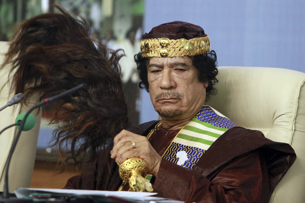 FILE - In this Sept. 8 2010 file photo, Libyan leader Moammar Gadhafi fans his face during the Forum of Kings, Princes, Sultans, Sheikhs and Mayors of Africa in Tripoli. President Trump and his hawkish national security adviser have both referenced the Libya model ahead of the much-vaunted summit with North Korea’s Kim Jun Un, but what is the context?(AP Photo/Abdel Magid Al Fergany, file)