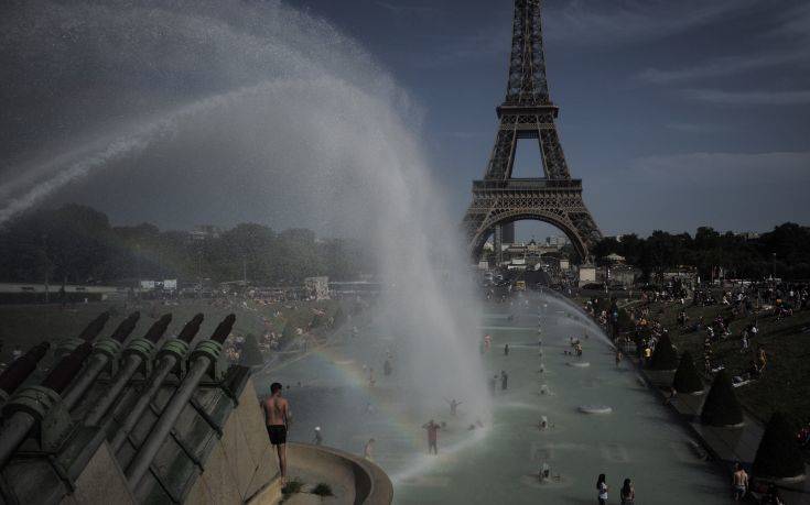 People cool off in the fountains of the Trocadero gardens, in front of the Eiffel Tower, in Paris, Friday, June 28, 2019. Schools are spraying kids with water and nursing homes are equipping the elderly with hydration sensors as France and other nations battle a record-setting heat wave baking much of Europe. (AP Photo/Lewis Joly)