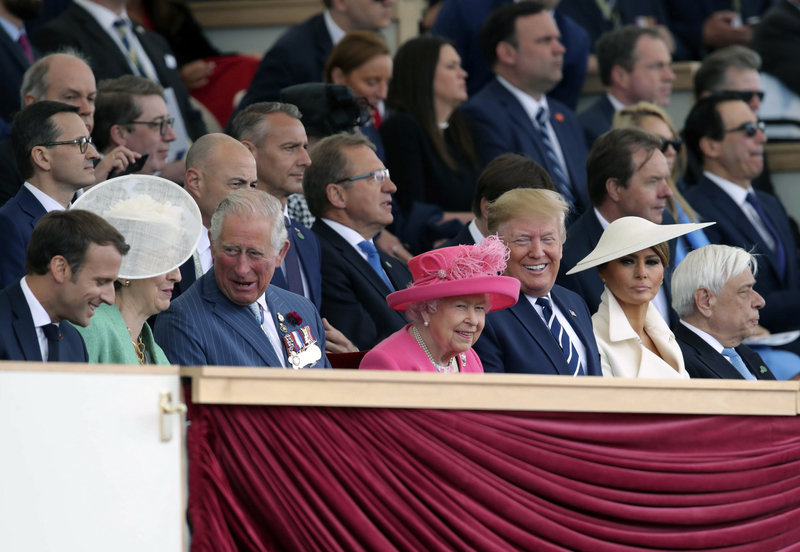 Dignitaries, from left, French President Emmanuel Macron, Britain's Prime Minister Theresa May, Prince Charles, Queen Elizabeth II, US President Donald Trump and Melania Trump, attend commemorations for the 75th Anniversary of the D-Day landings in Portsmouth, England, Wednesday June 5, 2019. Commemoration events are marking the 75th Anniversary of the D-Day landings when Allied forces stormed the beaches of Normandy in northern France during World War II. (Andrew Matthews/PA via AP)