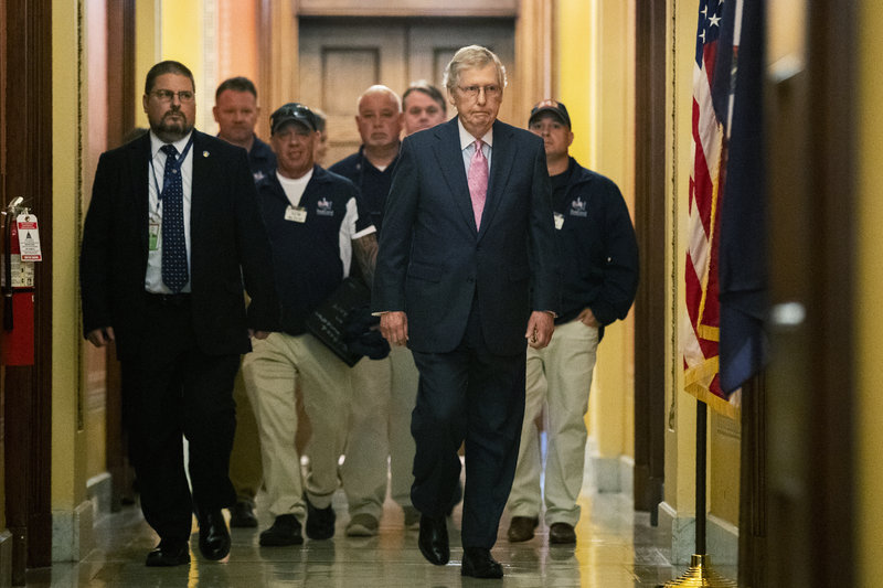 Senate Majority Leader Mitch McConnell walks with Sept. 11 first responders John Feal, second from left, Ret. Lt. Michael O'Connell, back right, and other first responders, following their meeting at McConnell's office on Capitol Hill in Washington, Tuesday, June 25, 2019. (AP Photo/Manuel Balce Ceneta)