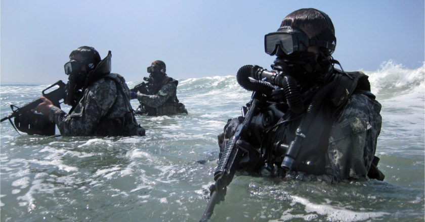Soldiers perform a seaborne infiltration as part of training at the Special Forces Underwater Operations School in Key West, Fla. The four-week long Combat Diver Qualification Course run by the U.S. Army John F. Kennedy Special Warfare Center and School, trains qualified combat divers in a variety of waterborne operations.