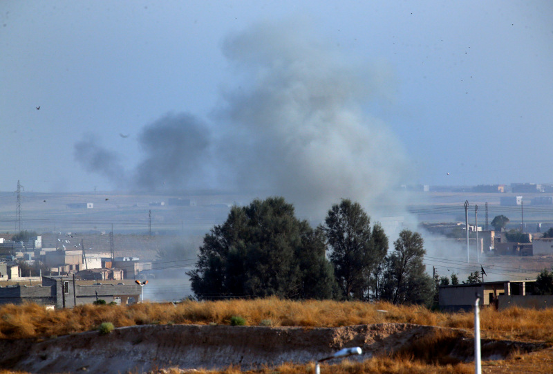 In this photo taken from the Turkish side of the border between Turkey and Syria, in Akcakale, Sanliurfa province, southeastern Turkey, smoke billows from a fire inside Syria during bombardment by Turkish forces Wednesday, Oct. 9, 2019. Turkey launched a military operation Wednesday against Kurdish fighters in northeastern Syria after U.S. forces pulled back from the area, with a series of airstrikes hitting a town on Syria's northern border. (AP Photo/Lefteris Pitarakis)