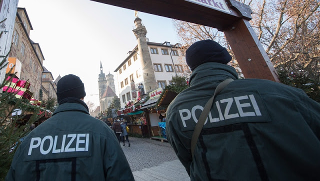 epa05684358 Two police officers standing at the Christmas market in the city centre of Stuttgart, Germany, 21 December 2016. Security measures have been increased across Germany after at least 12 people were killed and dozens injured when a truck on 19 December drove into the Christmas market at Breitscheidplatz in Berlin, in what authorities believe was a deliberate attack.  EPA/SILAS STEIN