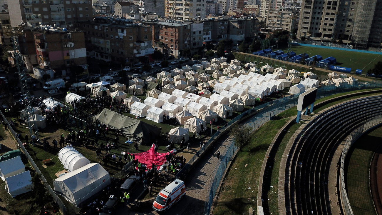 A general view of a makeshift camp at a soccer field in Durres, western Albania, Wednesday, Nov. 27, 2019. The death toll from a powerful earthquake in Albania has risen to 25 overnight as local and international rescue crews continue to search collapsed buildings for survivors. (AP Photo/Hektor Pustina)