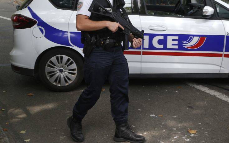 A French police officer stands guard after a knife attack Thursday, Aug. 23, 2018 in Trappes, west of Paris. A man flagged by French authorities as a suspected radical killed his mother and sister and seriously injured another woman in a knife attack Thursday that was quickly claimed by the Islamic State group. (AP Photo/Michel Euler)