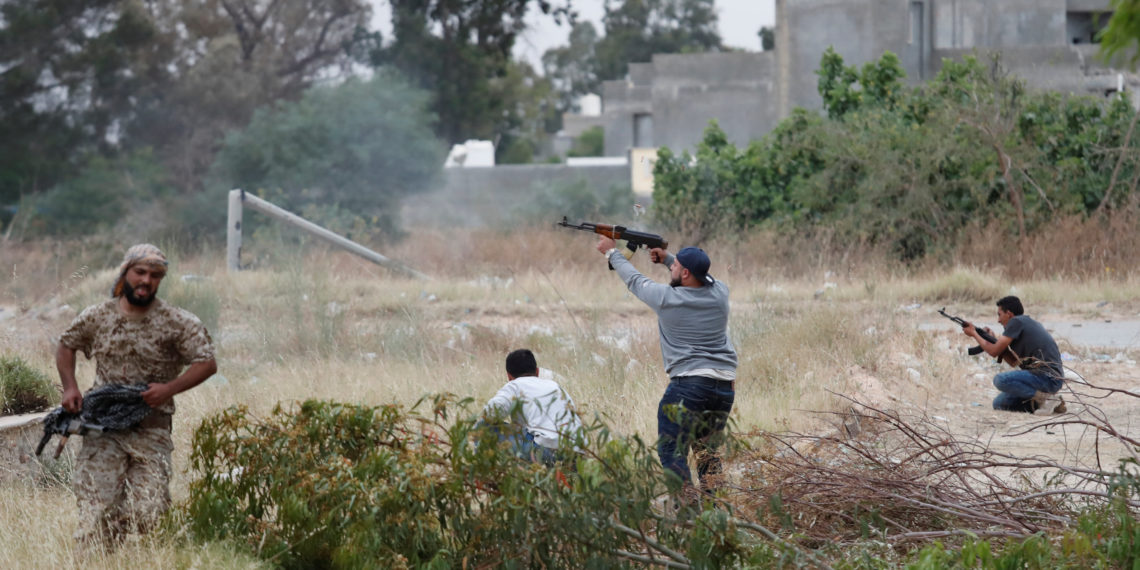 A fighter loyal to Libya's U.N.-backed government (GNA) fires an AK-47 during a clash with forces loyal to Khalifa Haftar at the outskirts of Tripoli, Libya May 21, 2019. REUTERS/Goran Tomasevic