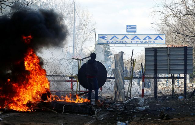 A migrants stands during clashes with Greek police, at the Turkey's Pazarkule border crossing with Greece's Kastanies, in Edirne, Turkey, February 29, 2020. REUTERS/Huseyin Aldemir