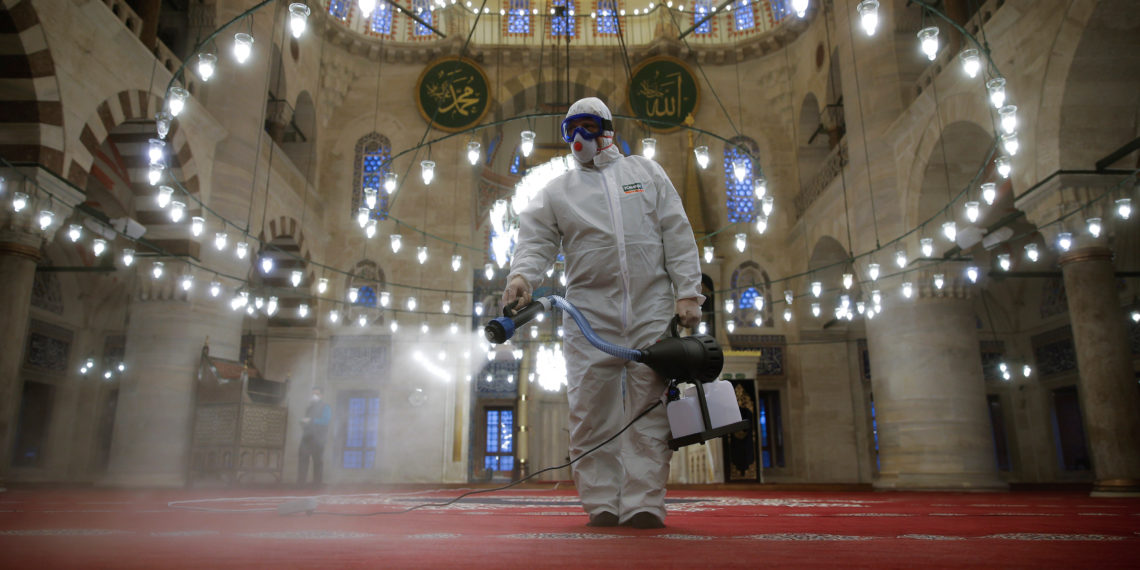 A municipality worker in a protective suit disinfects Kilic Ali Pasa Mosque due to coronavirus concerns in Istanbul, Turkey March 11, 2020. REUTERS/Kemal Aslan