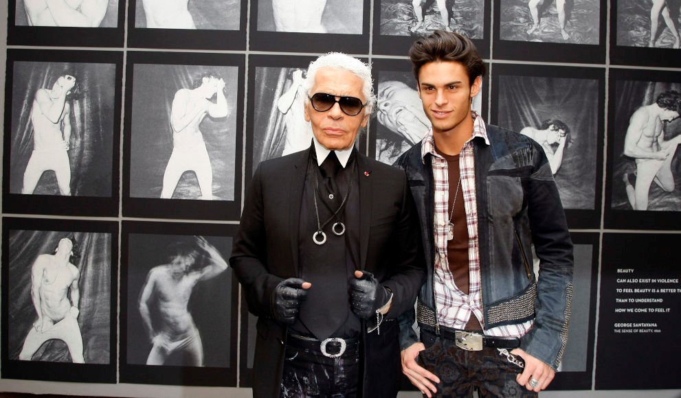 In this Tuesday,Sept. 14, 2010 picture made available Wednesday, Sept. 15, 2010 German fashion designer Karl Lagerfeld, left, poses with model Baptiste Giabiconi during the opening of his photo exhibition "Karl Lagerfeld, parcours de travail" at the European House of Photography in Paris, France. The exhibition runs from Sept. 15 to Oct. 31, 2010. (AP Photo/Francois Mori)
