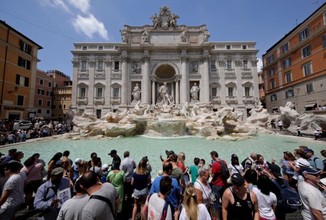 Tourists stand in front of the Trevi fountain in Rome, Italy, July 25, 2017.  REUTERS/Max Rossi