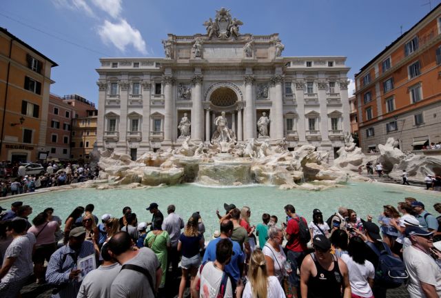 Tourists stand in front of the Trevi fountain in Rome, Italy, July 25, 2017. REUTERS/Max Rossi