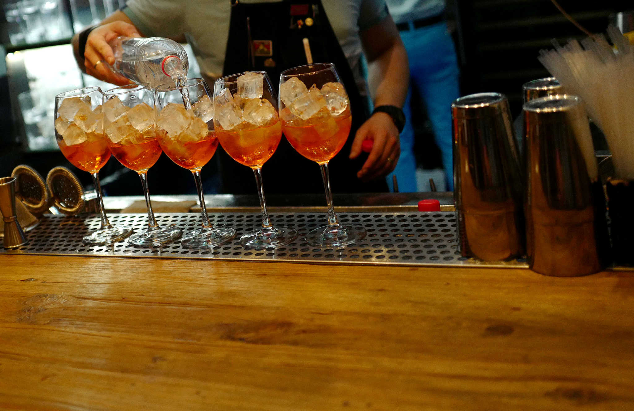 FILE PHOTO: A bartender prepares five Aperol Spritz drinks at a bar in Moscow, Russia July 13, 2018. REUTERS/Kai Pfaffenbach/File Photo