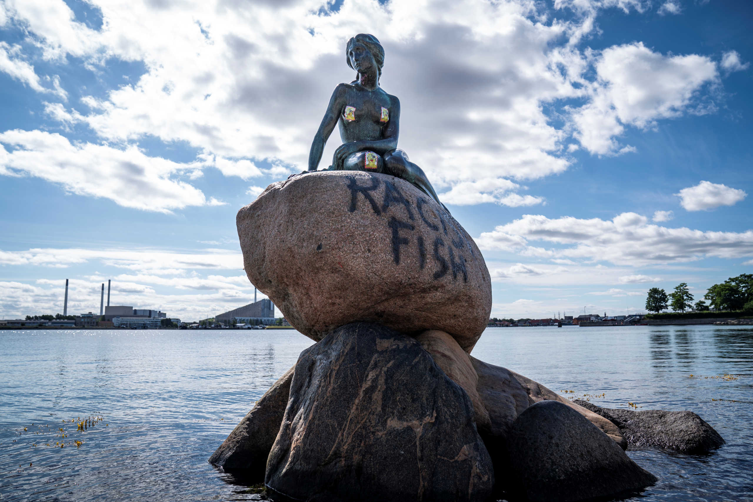 A graffiti reading "Racist Fish" is seen on a statue of "The Little Mermaid" in Copenhagen, Denmark July 3, 2020. Ritzau Scanpix/Niels Christian Vilmann via REUTERS    ATTENTION EDITORS - THIS IMAGE WAS PROVIDED BY A THIRD PARTY. DENMARK OUT. NO COMMERCIAL OR EDITORIAL SALES IN DENMARK.