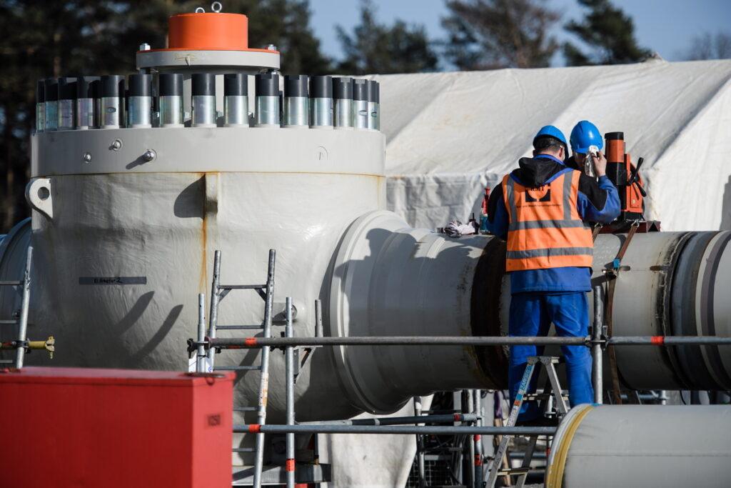 epa07465815 Workers work on a pipeline tube on the construction site of the Nord Stream 2 pipeline in Lubmin, Germany, 26 March 2019. The Nord Stream 2 pipeline with its length of 1230 kilometers runs from the Russian Baltic coast to Germany, subsea. It emerges in Lubmin near Greifswald in Mecklenburg-Western Pomerania.  EPA/CLEMENS BILAN