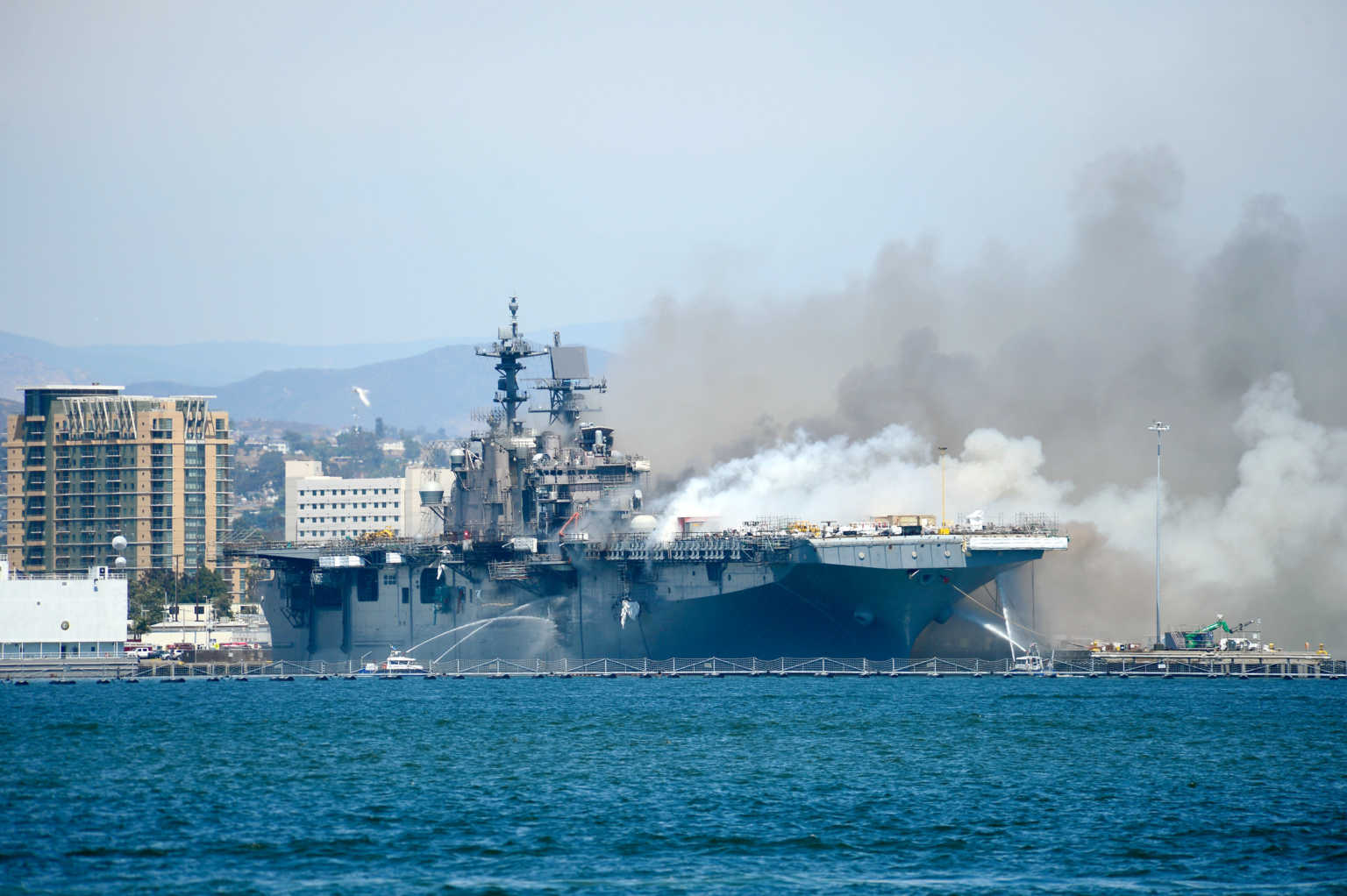 Port of San Diego Harbor Police Department boats combat a fire on board the U.S. Navy amphibious assault ship USS Bonhomme Richard at Naval Base San Diego, California, U.S. July 12, 2020. U.S. Navy/Lt. John J. Mike/Handout via REUTERS THIS IMAGE HAS BEEN SUPPLIED BY A THIRD PARTY.