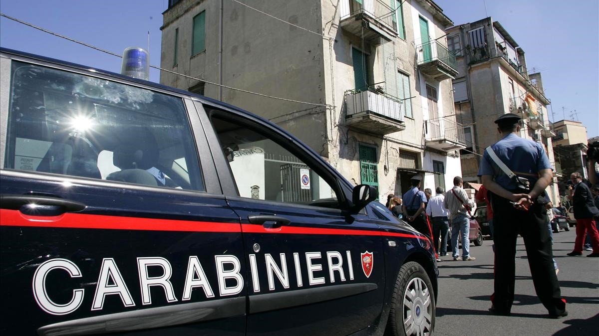Italian Carabinieri paramilitary police officers patrol the building where Paolo Di Lauro  nicknamed    Ciruzzo  O Milionario      Little Ciro  The Millionaire    was found and taken into custody  in Naples  southern Italy  Friday  Sept  16  2005   Di Lauro is suspected to be a leader of one of the feuding factions in the Camorra crime syndicate involved in a vicious turf war that sparked dozens of murders last year   AP Photo  Salvatore La Porta