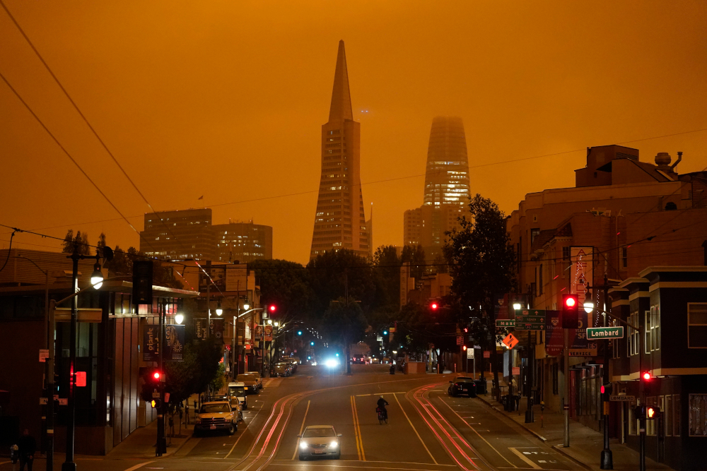 Looking up Columbus Ave. the Transamerica Pyramid and Salesforce Tower are covered with smoke from wildfires late Wednesday morning, Sept. 9, 2020, in San Francisco. (AP Photo/Eric Risberg)