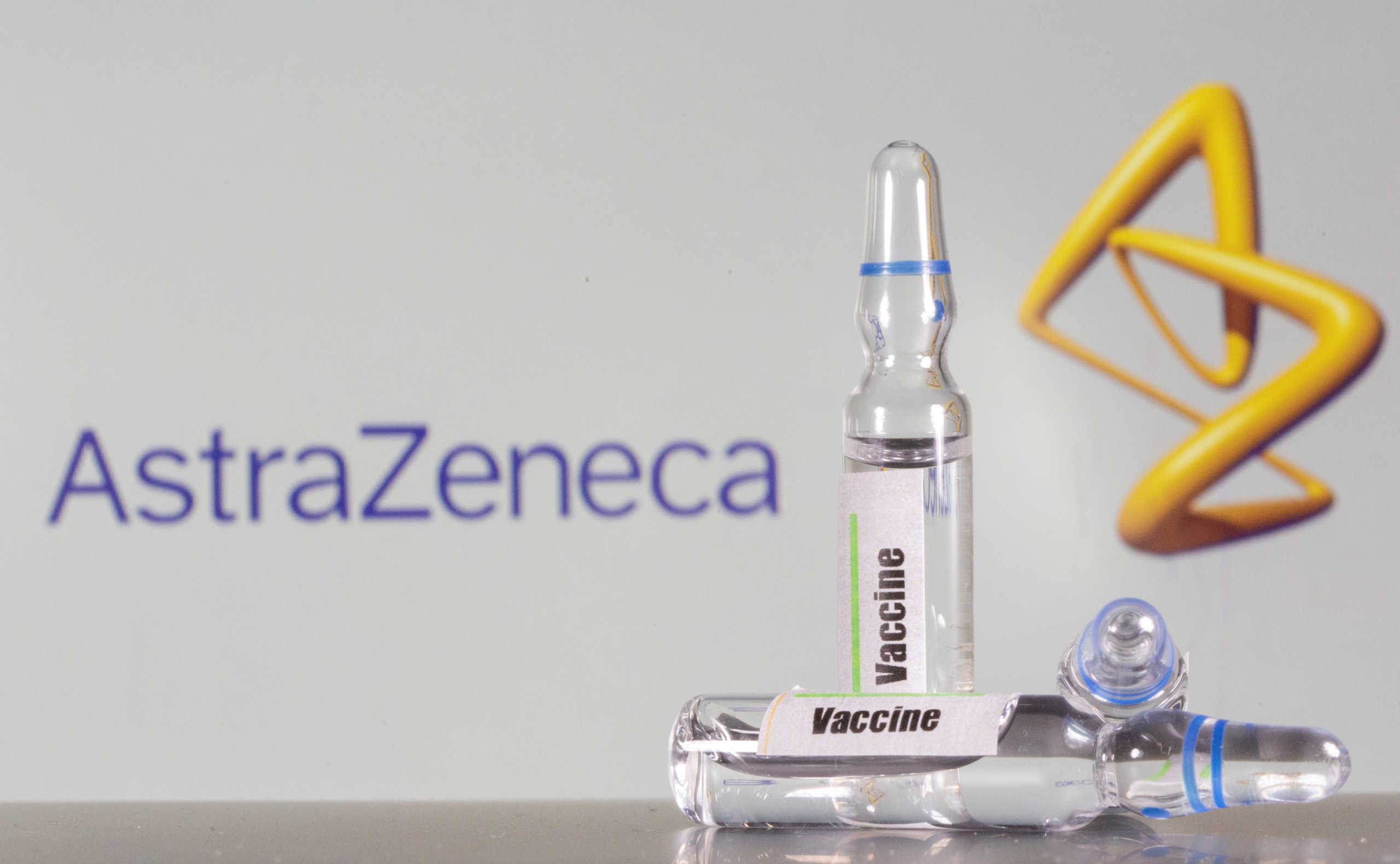 FILE PHOTO: A test tube labelled with the Vaccine is seen in front of AstraZeneca logo in this illustration taken, September 9, 2020. REUTERS/Dado Ruvic/Illustration/File Photo