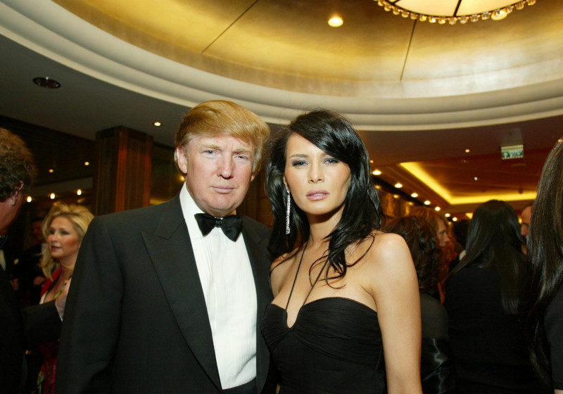 **FILE**Donald Trump and Melania Knauss pose as they arrive for a charity event on board the Queen Mary 2  on April 24, 2004 in New York. The couple weds Saturday evening, Jan. 22, 2005, in Palm Beach, Fla. (AP Photo/Stuart Ramson)