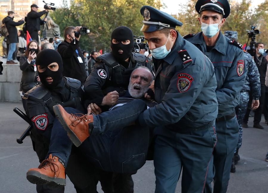epa08816084 Armenian police officers detain a protestor during an opposition rally in the Freedom Square in Yerevan, Armenia, 12 November 2020. Protesters  demanded the resignation of Armenian Prime Minister Nikol Pashinyan and his government. The unrest  and protest erupted in Yerevan on 10 November 2020 after Armenian Prime Minister and Presidents of Azerbaijan and Russia signed a trilateral statement announcing the halt of ceasefire and all military operations in the Nagorno-Karabakh conflict zone.  EPA/STEPAN POGHOSYAN/PHOTOLURE MANDATORY CREDIT