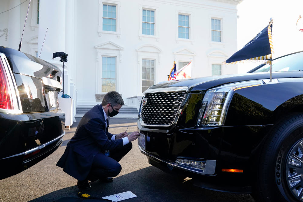 A U.S. Secret Service agent changes the license plate on President Joe Biden's limousine near the North Portico of the White House, Wednesday, Jan. 20, 2021, in Washington. (AP Photo/Alex Brandon, Pool)