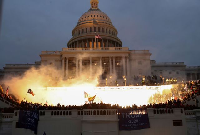 An explosion caused by a police munition is seen while supporters of U.S. President Donald Trump gather in front of the U.S. Capitol Building in Washington, U.S., January 6, 2021. REUTERS/Leah Millis TPX IMAGES OF THE DAY