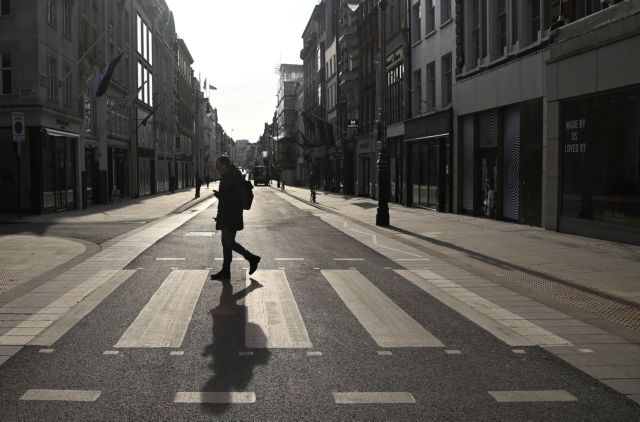 A person crosses an almost empty New Bond Street, as official figures are published for UK GDP in 2020, London, Britain, February 12, 2021. REUTERS/Toby Melville